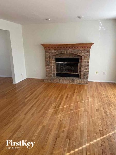 a living room with a fireplace and a wooden floor