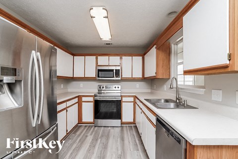 A kitchen with wooden cabinets and stainless steel appliances.