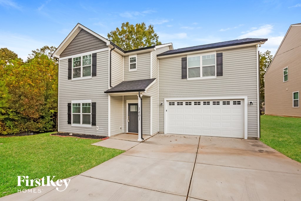 A two-story house with a garage is for sale.