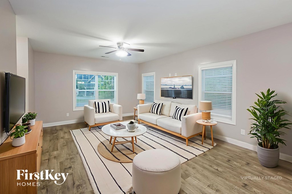 A living room with a television, two couches, and a coffee table.