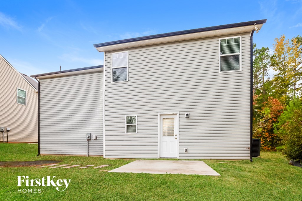 A small house with a white door and a window is for sale.