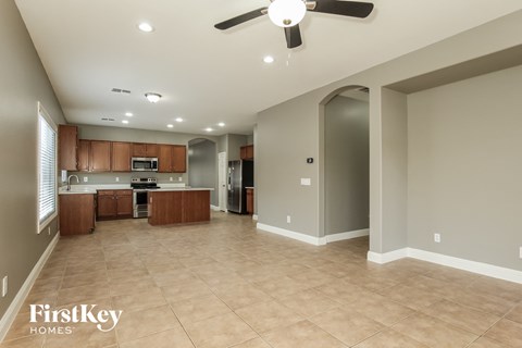 an open kitchen and living room with a ceiling fan