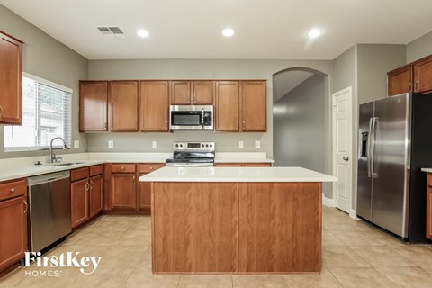 a kitchen with wooden cabinets and stainless steel appliances