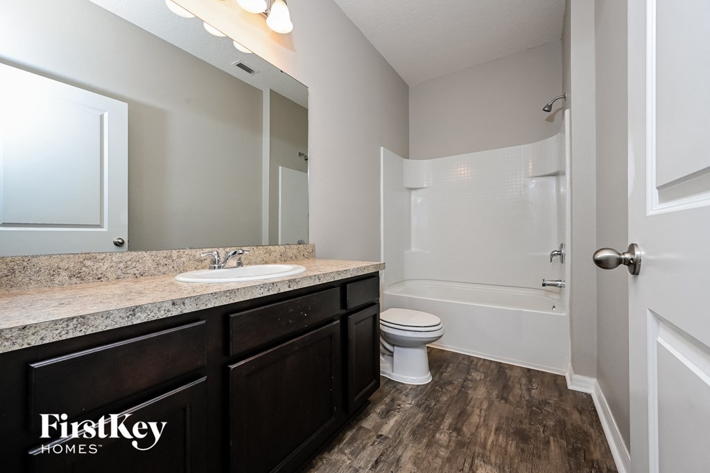 a bathroom with a sink and a toilet and a shower