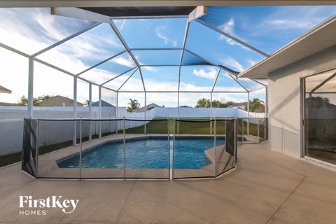 a small pool in a glass enclosure on a patio