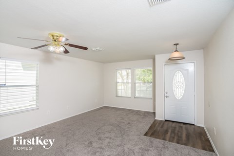 a bedroom with a ceiling fan and a white door