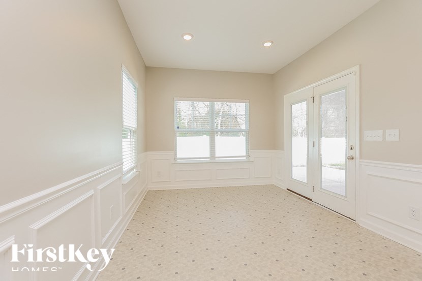 A spacious room with a window and a door.