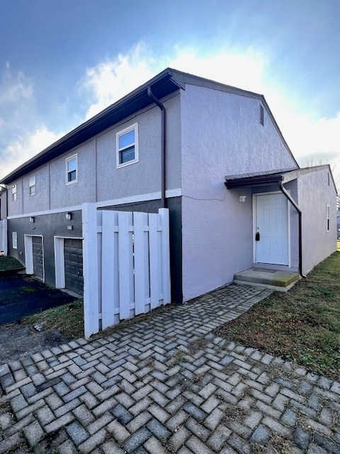 A house with a grey and white exterior and a white door.