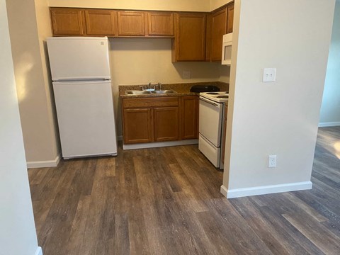 a kitchen with a refrigerator and a sink