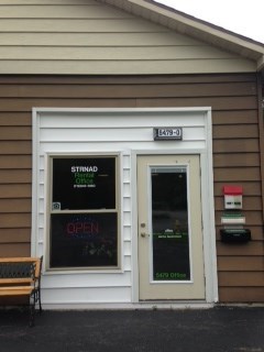 a store front with two doors and a sign in the window