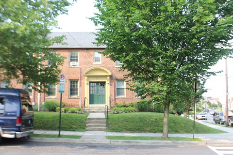 A tree is in front of a house.