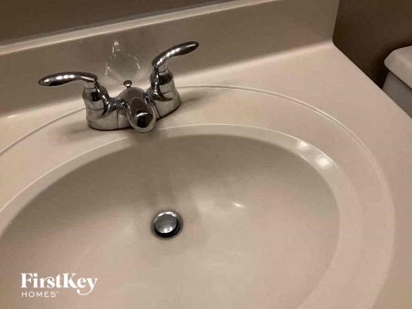 a bathroom sink with a faucet on top of it