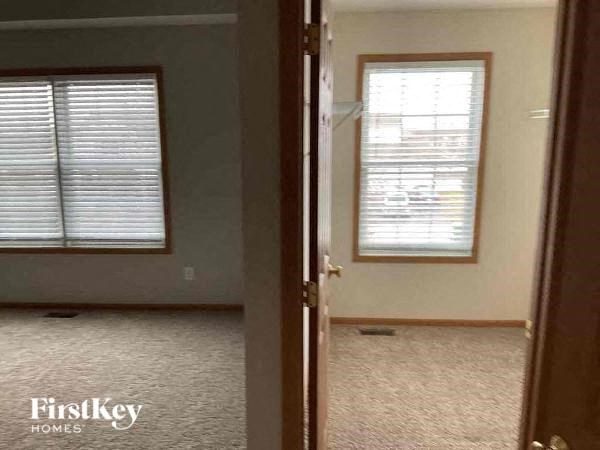 an empty room with a window and a door