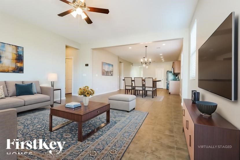 A living room with a couch, a coffee table, and a television.
