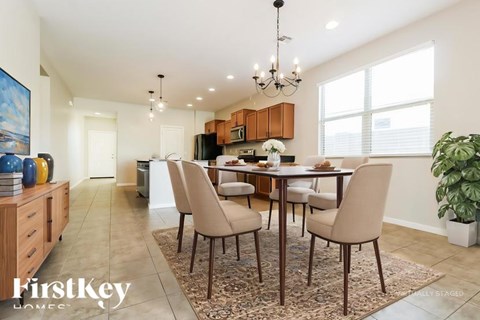 A dining room with a table set for six.