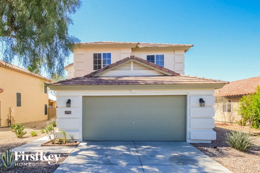 A house with a garage door that says Firstkey Homes.