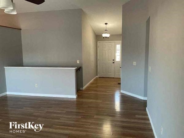 A room with wooden floors and a white door.
