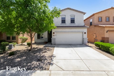 a house with a white garage door and a tree