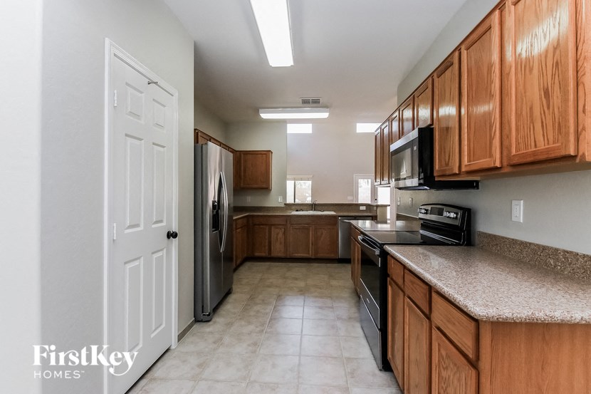 a large kitchen with wooden cabinets and stainless steel appliances