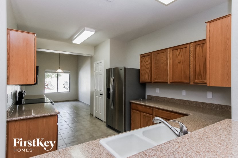 a kitchen with wooden cabinets and a sink and a refrigerator