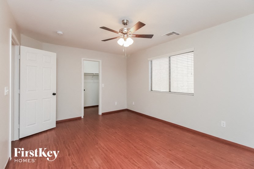 a living room with wood flooring and a ceiling fan