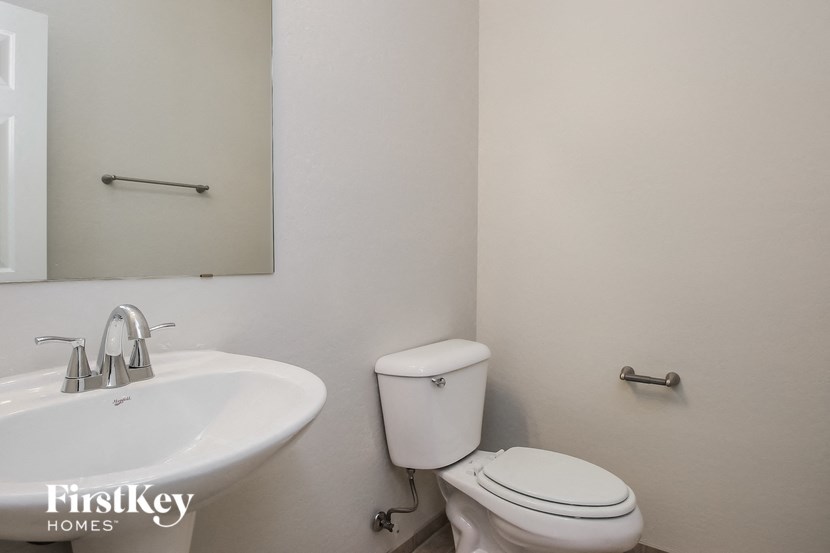 a bathroom with a sink and a toilet and a mirror