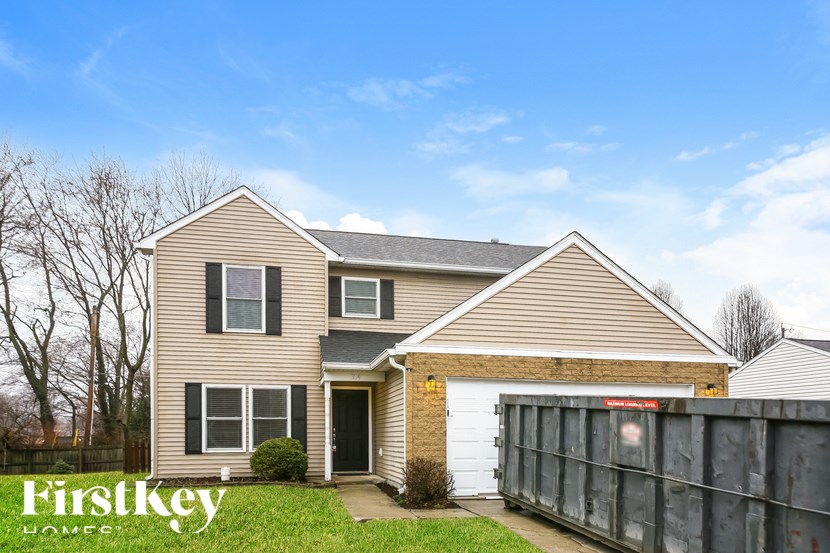 A two-story house with a garage is for sale.