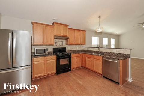 A kitchen with wooden cabinets and a stainless steel refrigerator.
