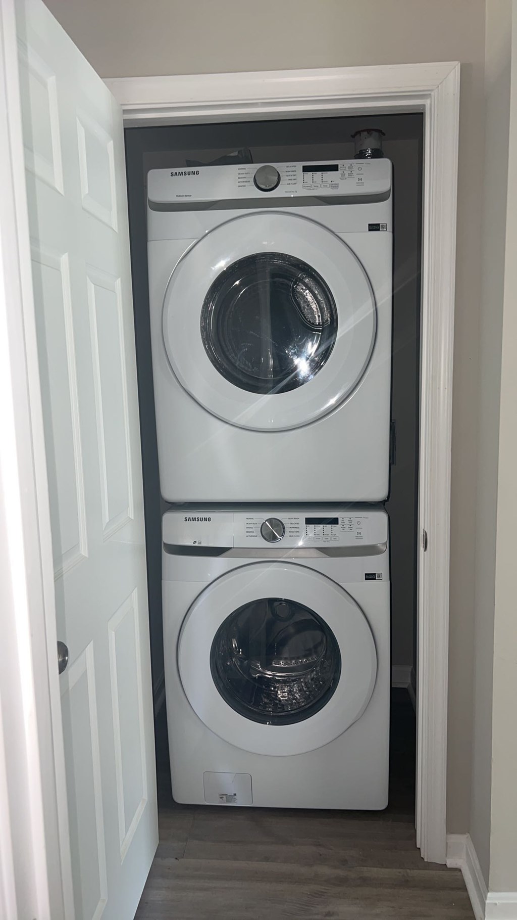 Two washing machines in a small laundry room.