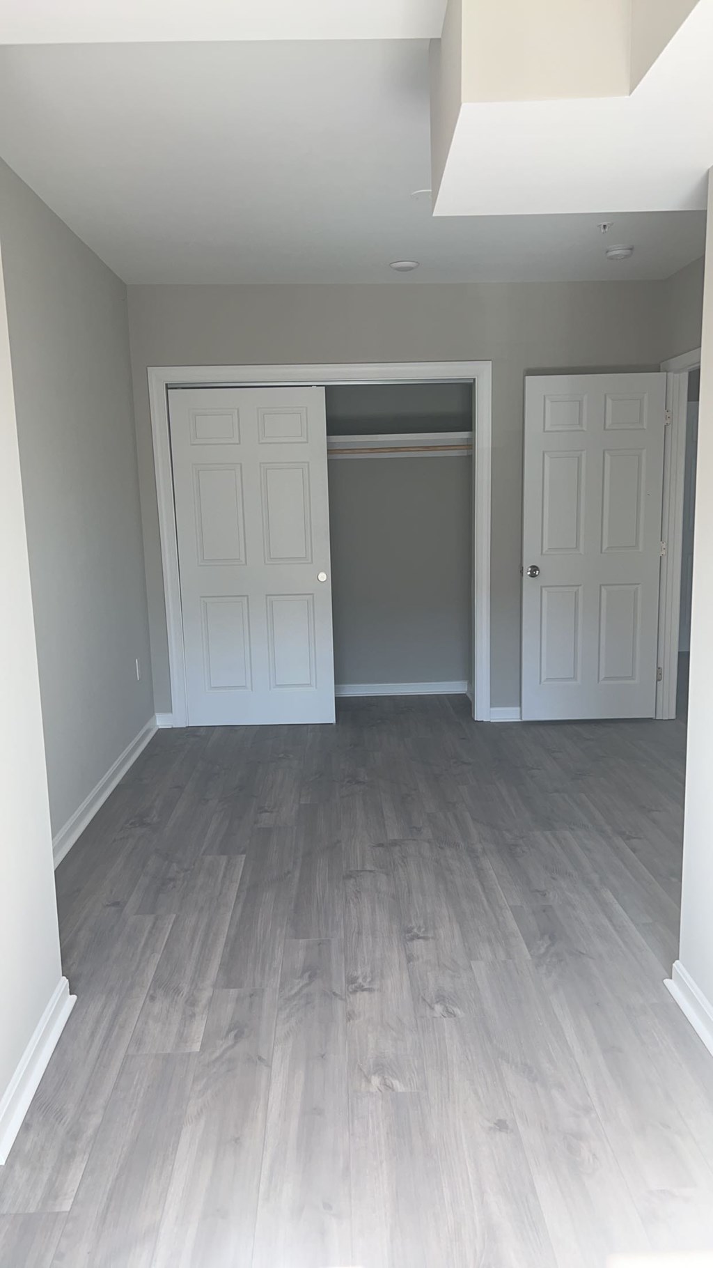 A room with a grey floor and white walls.