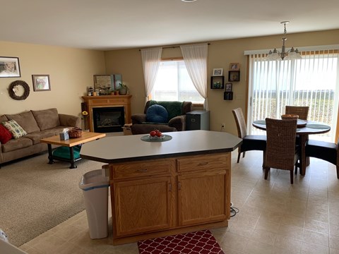 a dining room and living room with a table and chairs
