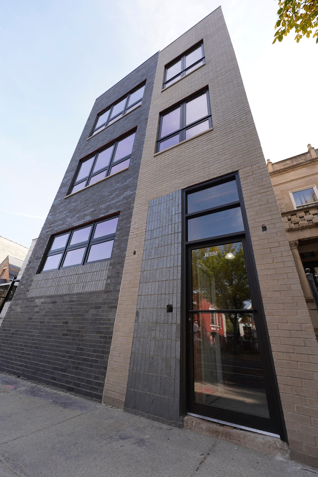 a tall brick building with a glass door