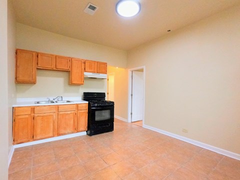 a kitchen with wood cabinets and a black stove