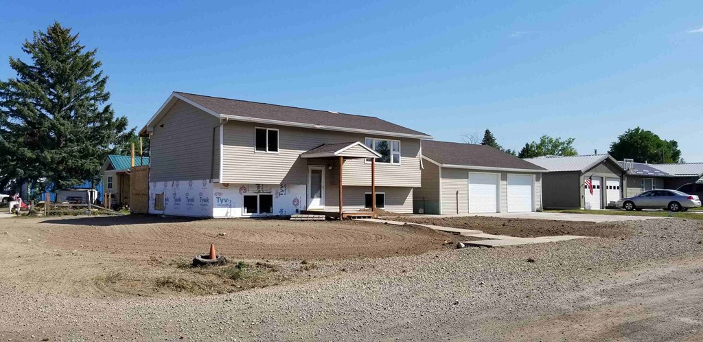 a house is being constructed on a dirt lot