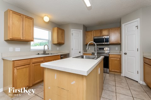 A kitchen with wooden cabinets and a white countertop.