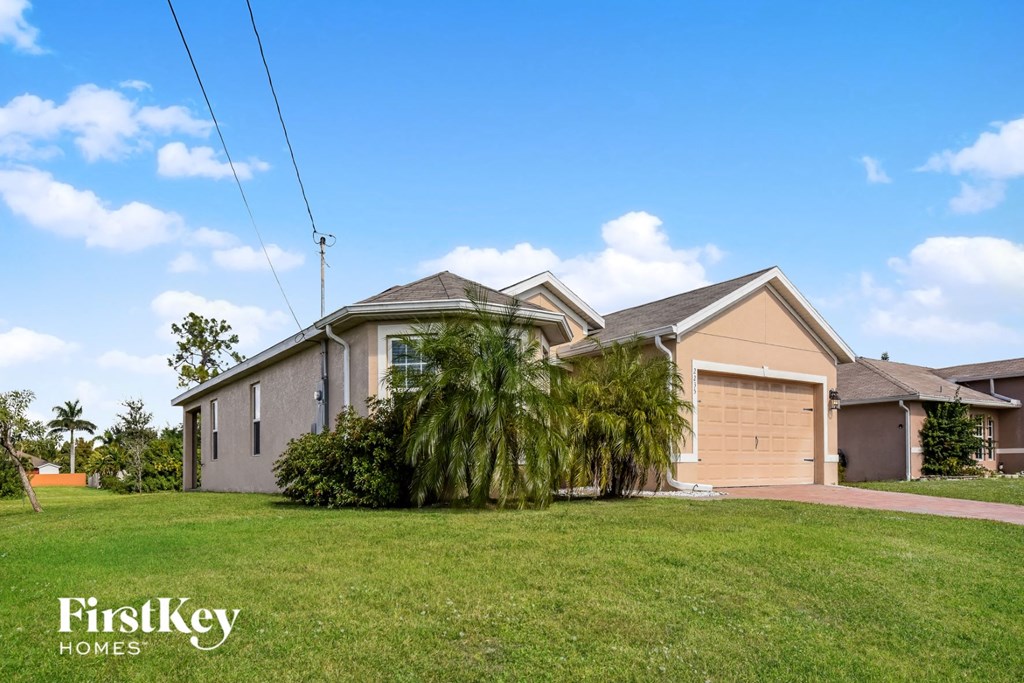 a home with a lawn and a garage