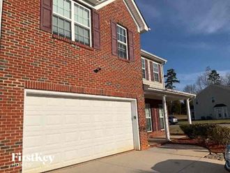 a brick house with a white garage door