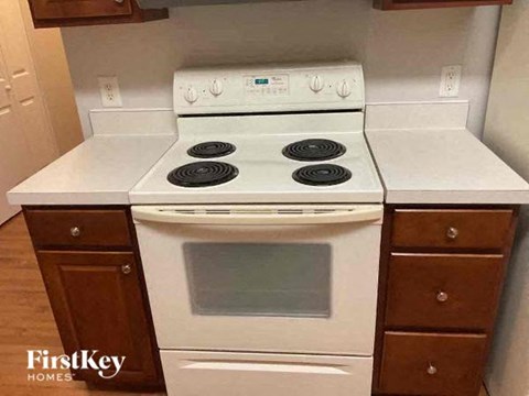 a white stove top oven sitting in a kitchen
