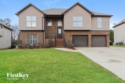 A two-story house with a garage is for sale.