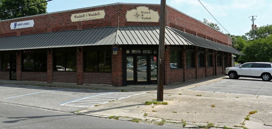 a brick building with a car parked in front of it