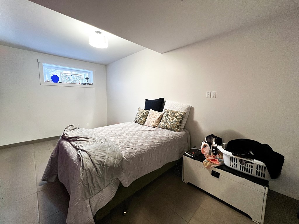 a small bedroom with a bed and a dresser