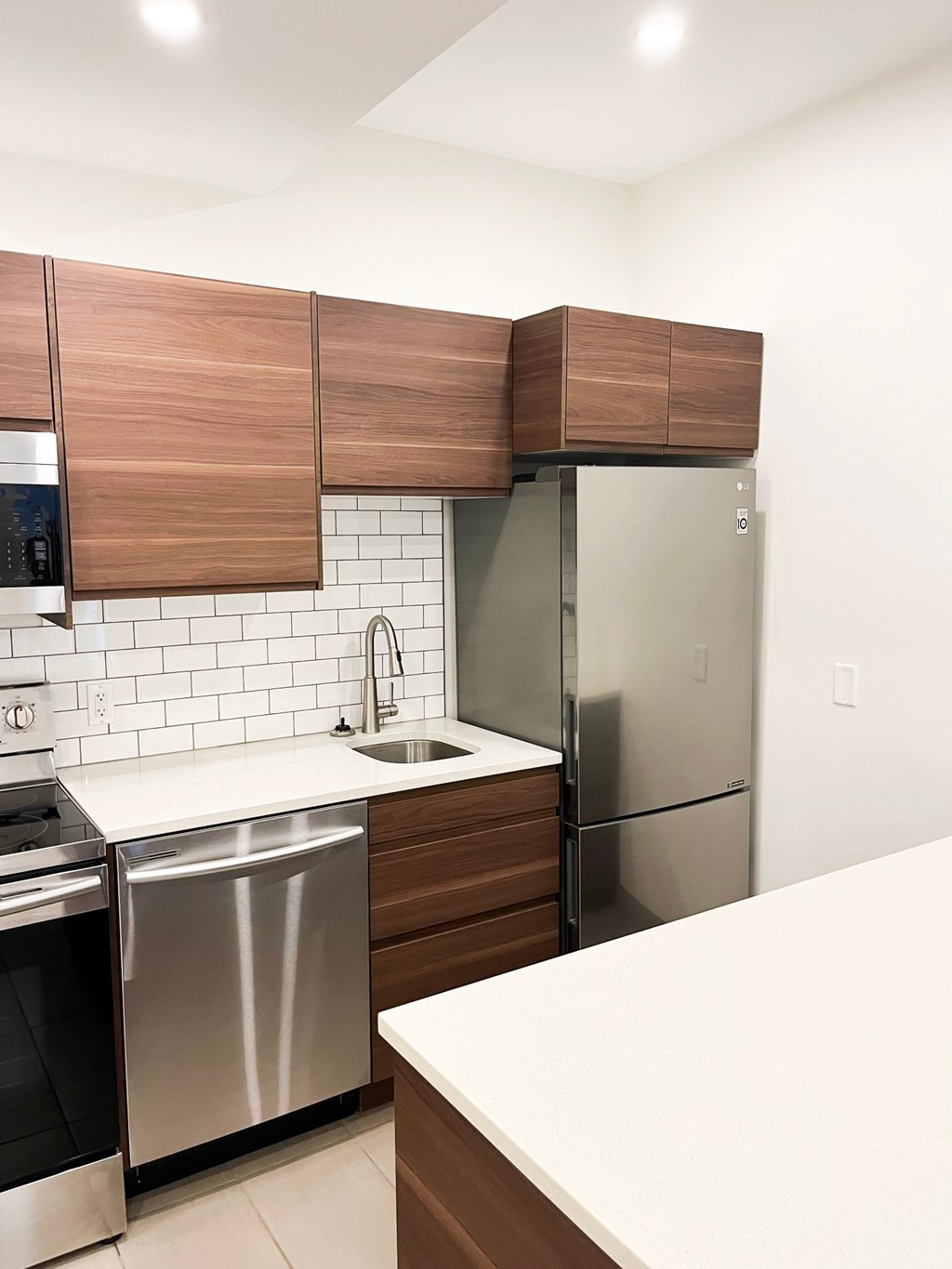 a kitchen with stainless steel appliances and wooden cabinets