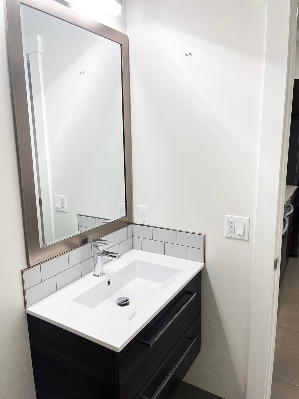 a small bathroom with a sink and a mirror