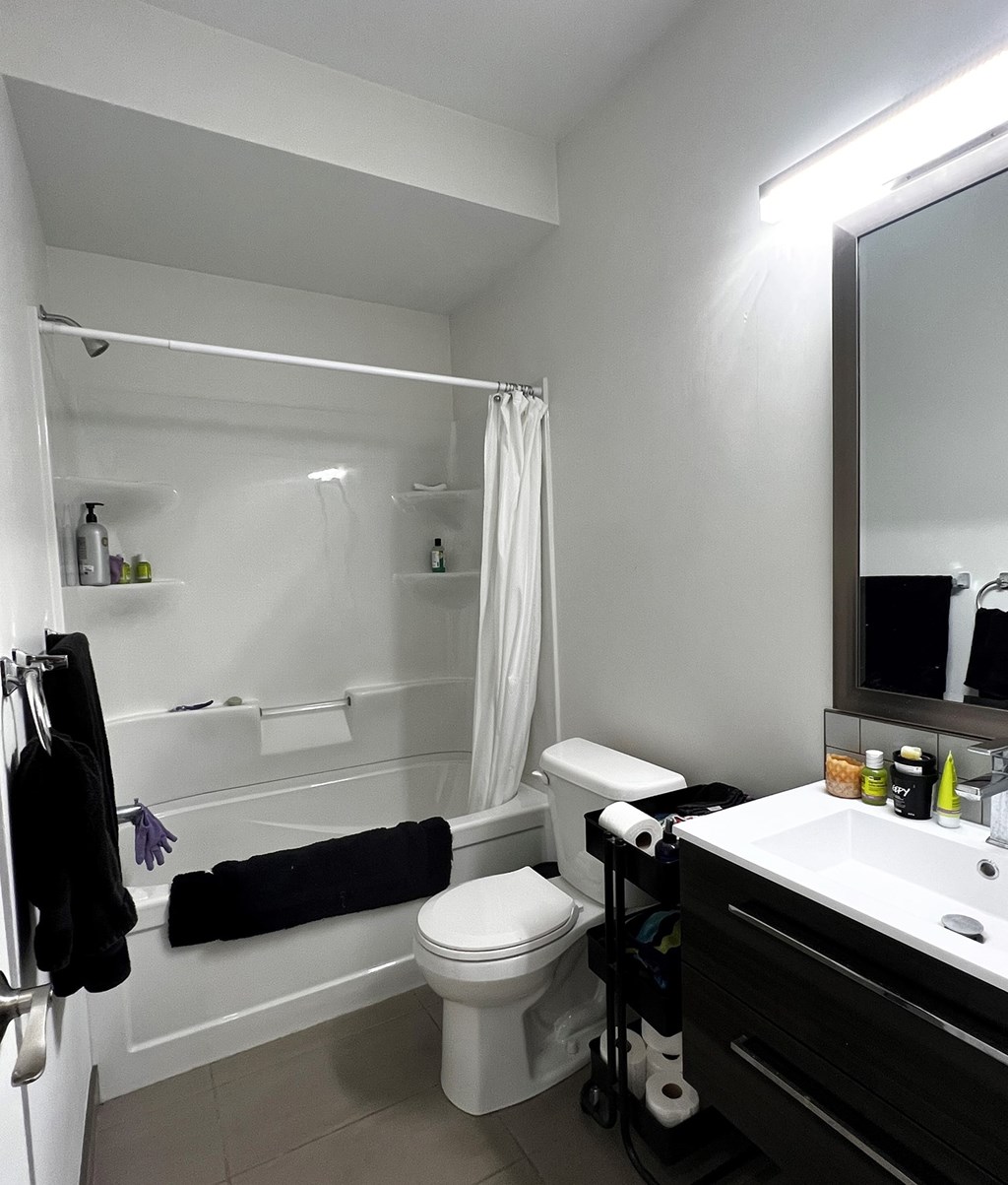 a bathroom with a toilet and a tub and a sink