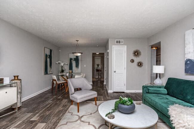 a living room with a green couch and a table