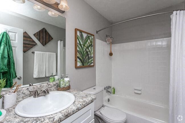 a white bathroom with a sink and a toilet
