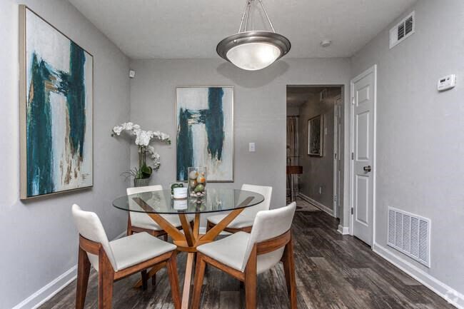 a dining room with a table and chairs