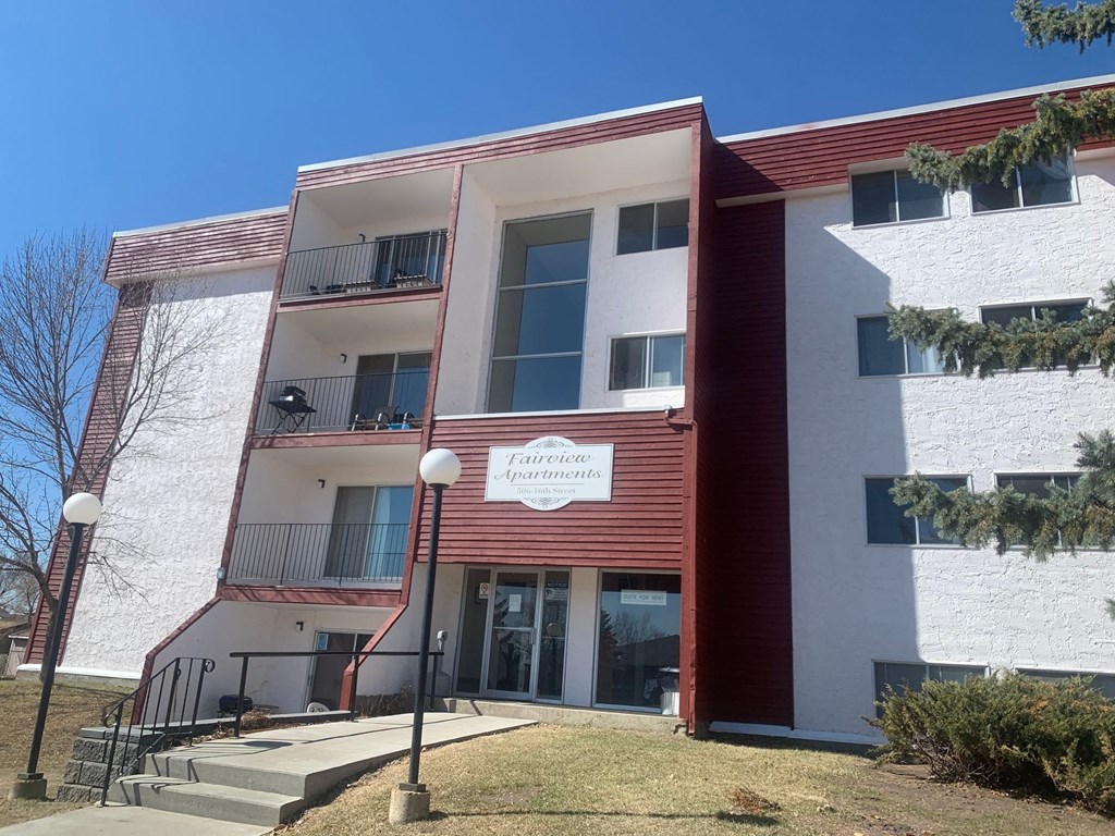 the front of a building with stairs in front of it