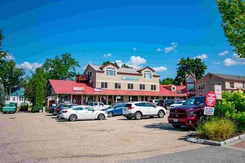 a parking lot full of cars in front of a building