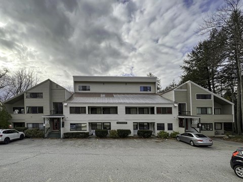 a large white building with cars parked in front of it